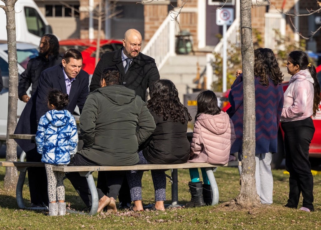  Brampton Mayor Patrick Brown, left, talks to people at the scene of a house fire that left two dead, four injured and three missing in at a semi-detached home on Banas Way on Thursday, Nov. 20, 2025.