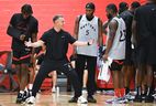 Toronto Raptors head coach Darko Rajakovic (second from left) talks with players Immanuel Quickley (5) and Jamal Sheed (23) during an open training session at McGill University in Montreal, Friday, October 4, 2024.