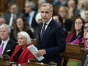 Prime Minister Mark Carney rises during Question Period, on Parliament Hill in Ottawa, Monday, Nov. 17, 2025.