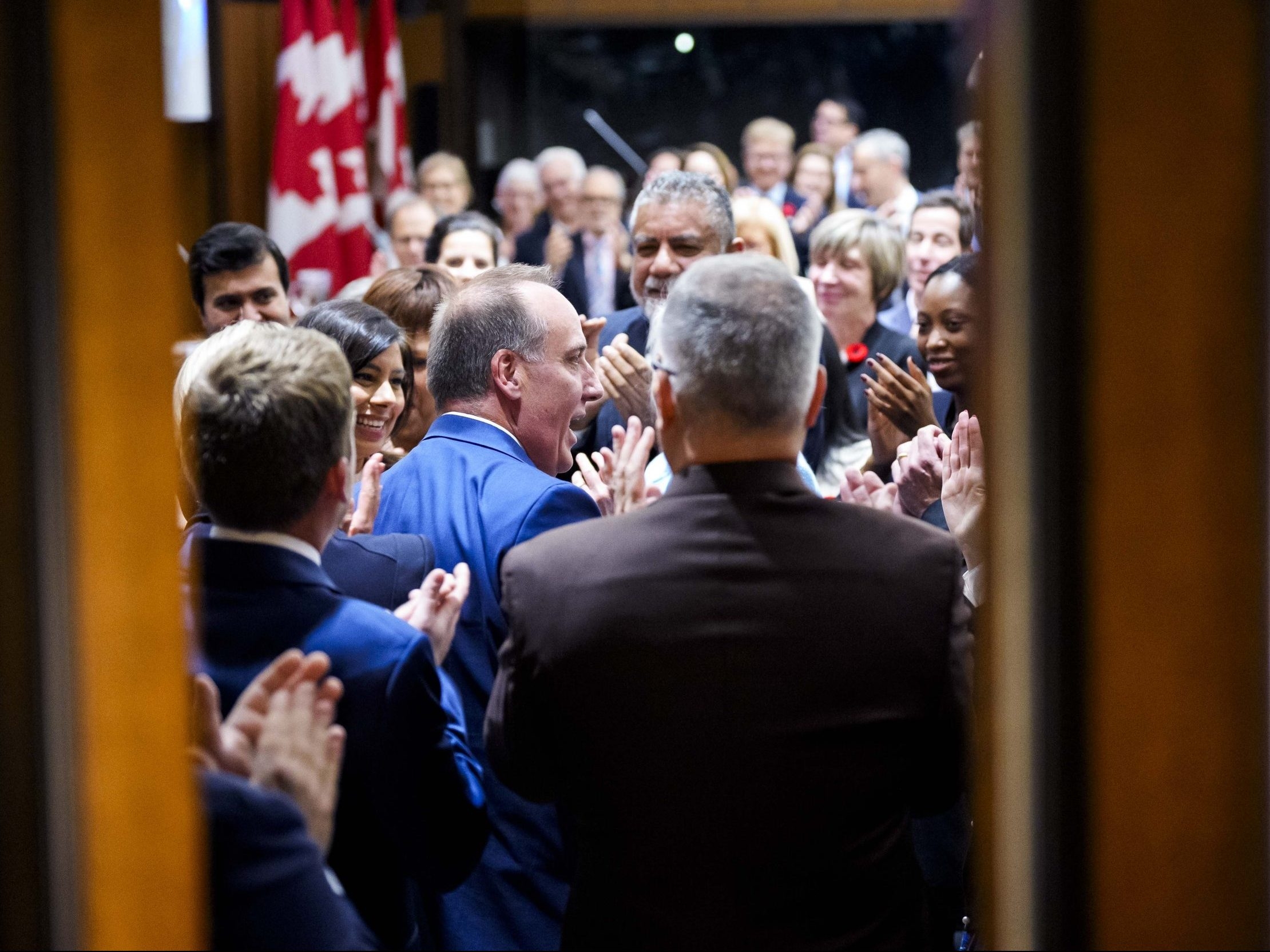  MP Chris d’Entremont, who crossed the floor from the Conservatives to join the Liberals, is applauded by his new colleagues as he arrives at a meeting of the Liberal caucus on Parliament Hill in Ottawa, on Wednesday, Nov. 5, 2025.