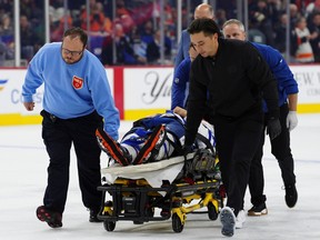 Maple Leafs defenceman Chris Tanev is taken off the ice on a stretcher by medical staff after a collision during the third period game against the Flyers in Philadelphia, Saturday, Nov. 1, 2025.