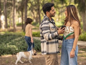 Couple ignoring their son while he is walking a dog