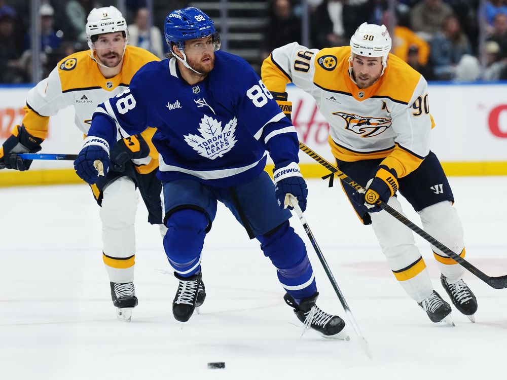 Maple Leafs winger William Nylander (88) is chased by Nashville Predators forwards Filip Forsberg (9) and Ryan O'Reilly (90) during the second period in Toronto on Tuesday, October 14, 2025.  