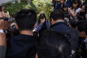 A resident reacts as she speaks to the media in the aftermath of a major fire that swept through several apartment blocks at the Wang Fuk Court residential estate in Hong Kong's Tai Po district, Friday, Nov. 28, 2025.
