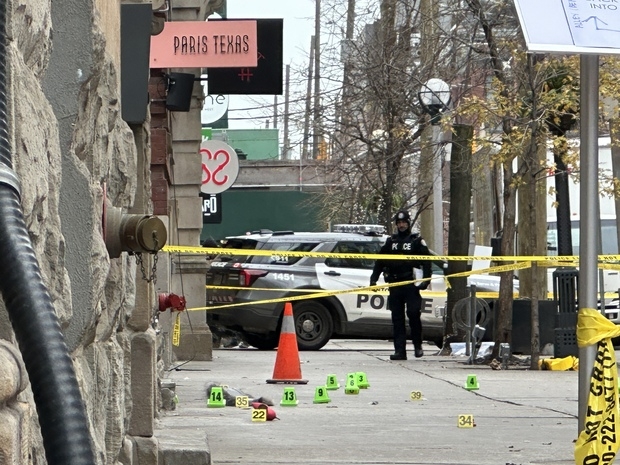  Toronto Police tape and markers at the scene of an early morning shooting on King St. W., west of Spadina Ave., that wounded a man. JACK BOLAND/TORONTO SUN
