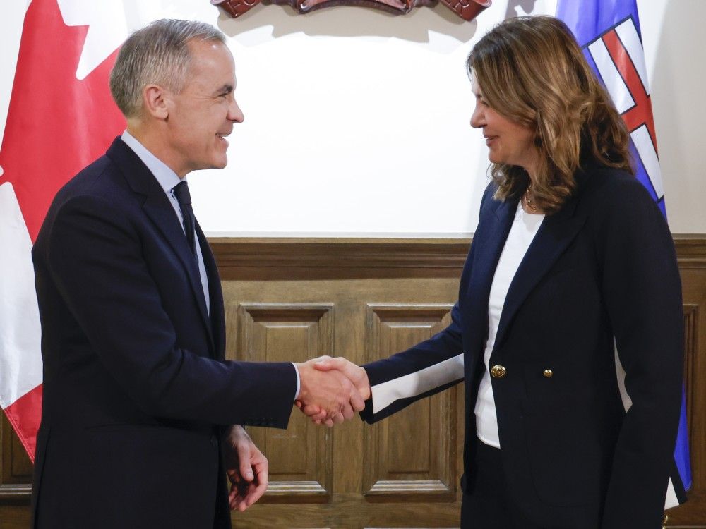 Prime Minister Mark Carney, left, meets with Alberta Premier Danielle Smith in Calgary, Thursday, Nov. 27, 2025.