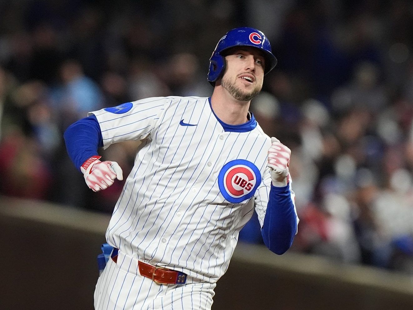 Kyle Tucker of the Chicago Cubs runs around the bases after hitting a home run.