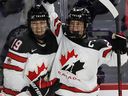 Canada's Marie-Philip Poulin (right) celebrates with Brianna Jenner after scoring against the United States in the final game of the 2022-23 series in Laval, Quebec, February 22, 2023.