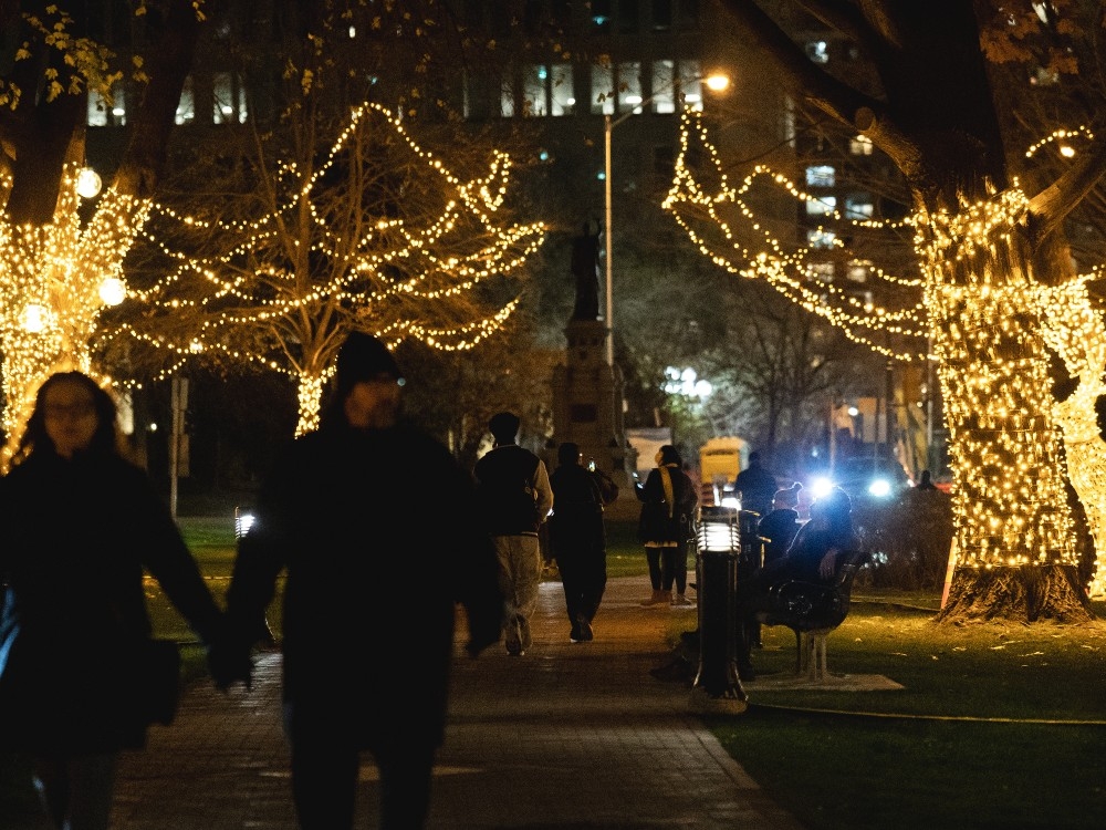  Visitors to Queen’s Park, the Ontario provincial legislature, walk amid the front lawn’s Christmas decorations, in Toronto, Friday, Nov. 21, 2025.