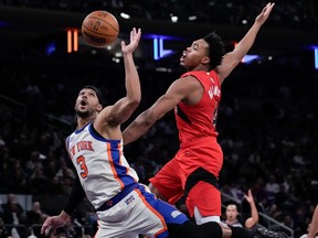 New York Knicks guard Josh Hart fights for control of the ball with Toronto Raptors forward Scottie Barnes, Sunday, Nov. 30, 2025, in New York.