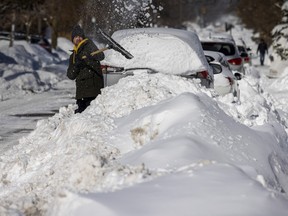 A man shovels snow in Toronto on Feb. 17, 2025.