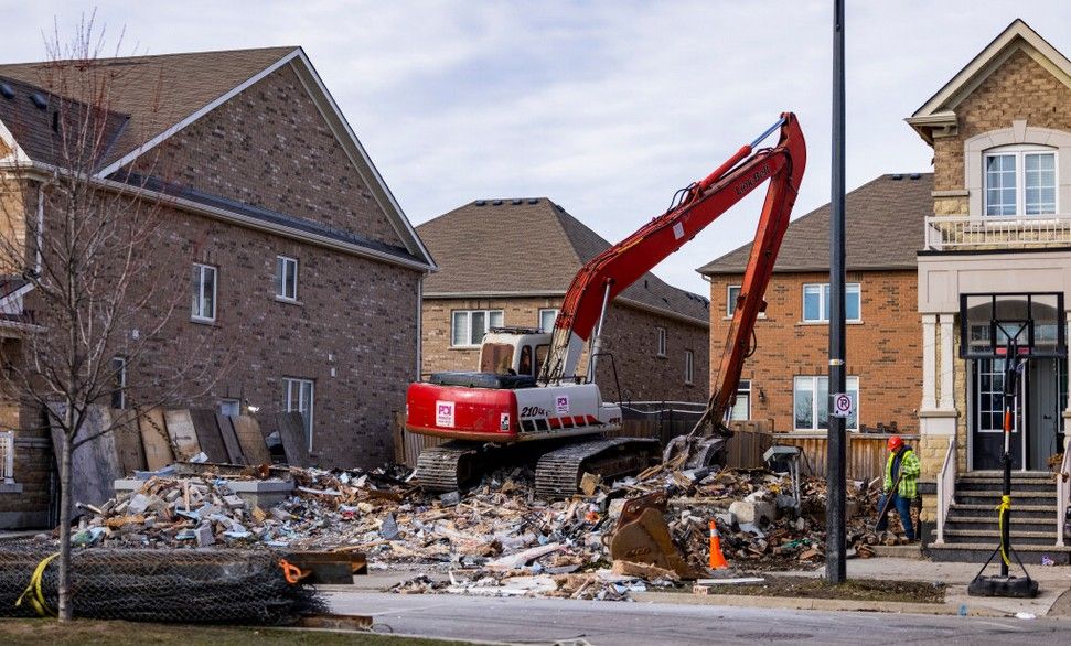 A demolition crew is pictured Monday at a home -- on Banas Way, in the McLaughlin-Remembrance Rds. area -- which was devastated by a fatal fire on Nov. 20. Five occupants died and others are in hospital with serious injuries. (Ernest Doroszuk, Toronto Sun)

