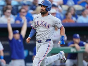 Texas Rangers' Marcus Semien runs home to score on an RBI single hit by Jonah Heim during the second inning of a baseball game against the Kansas City Royals, Monday, Aug. 18, 2025, in Kansas City, Mo.