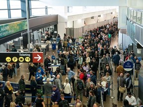Travelers arrive at Seattle-Tacoma International Airport in Seattle, Washington, Friday, November 7, 2025. Airlines across the U.S. have begun canceling flights scheduled for the coming days as the longest government shutdown in history upends air travel and forces thousands of passengers to change their travel plans.