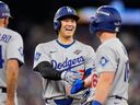 Shohei Ohtani and Will Smith of the Los Angeles Dodgers talk during the eighth inning of Game 6 of the Baseball World Series against the Toronto Blue Jays on Friday, Oct. 31, 2025, in Toronto.