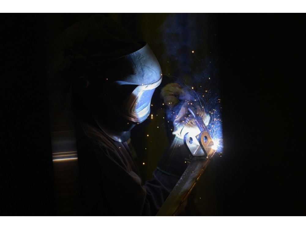 A welder works at Arctic Snowplow’s factory in London, Ontario, Canada. (Geoff Robins/AFP)