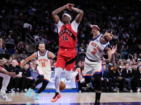 Toronto Raptors guard Ja'Kobe Walter fails to drive past New York Knicks guard Josh Hart during Sunday’s game.
