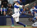 Toronto Blue Jays designated hitter George Springer hits a single against the Los Angeles Dodgers during Game 7 of the World Series.