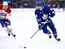 William Nylander of the Toronto Maple Leafs skates with the puck as Ivan Demidov of the Montréal Canadiens defends.