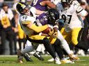 T.J. Watt of the Pittsburgh Steelers tackles Derrick Henry of the Baltimore Ravens.