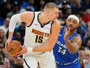 Denver Nuggets centre Nikola Jokic looks for a way around Orlando Magic centre Wendell Carter Jr. during a game on Dec. 27.