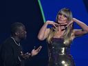 (L-R) US comedian Kevin Hart and German US model and host Heidi Klum speak on stage during the draw for the 2026 FIFA Football World Cup taking place in the US, Canada and Mexico, at the Kennedy Center, in Washington, DC, on December 5, 2025.