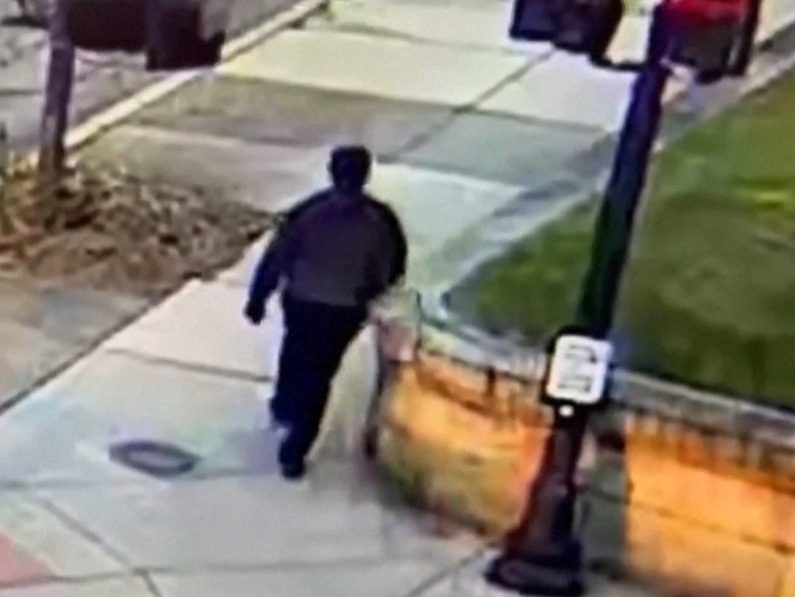  This video grab from a CCTV footage released by the Providence Police Department shows the suspect in the Brown University shooting walking along a road near the campus in Providence on December 13, 2025. 