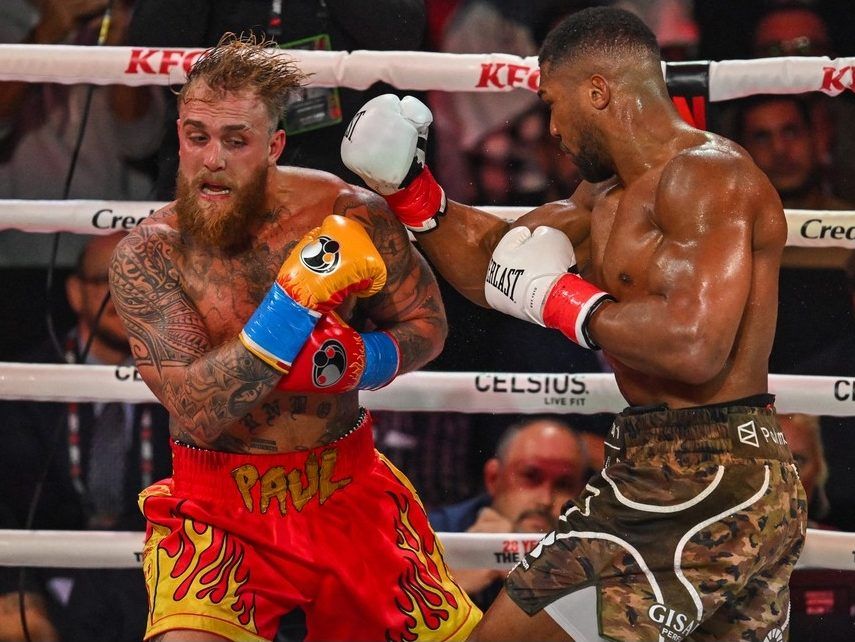 US boxer and influencer Jake Paul (L) and British boxer Anthony Joshua fight in a non-title heavyweight bout at the Kaseya Center in Miami, Florida on December 19, 2025.