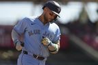 Blue Jays' Bo Bichette rounds third base after hitting a two-run home run in the ninth inning against the Cincinnati Reds, Monday, Sept. 1, 2025, in Cincinnati.