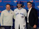 Dylan Cease, centre, pitcher for the Toronto Blue Jays, poses for a photo with his agent Scott Boras, left, and Ross Atkins, general manager Blue Jays, during a news conference at baseball's Winter Meetings, Tuesday, Dec. 9, 2025, in Orlando, Fla.