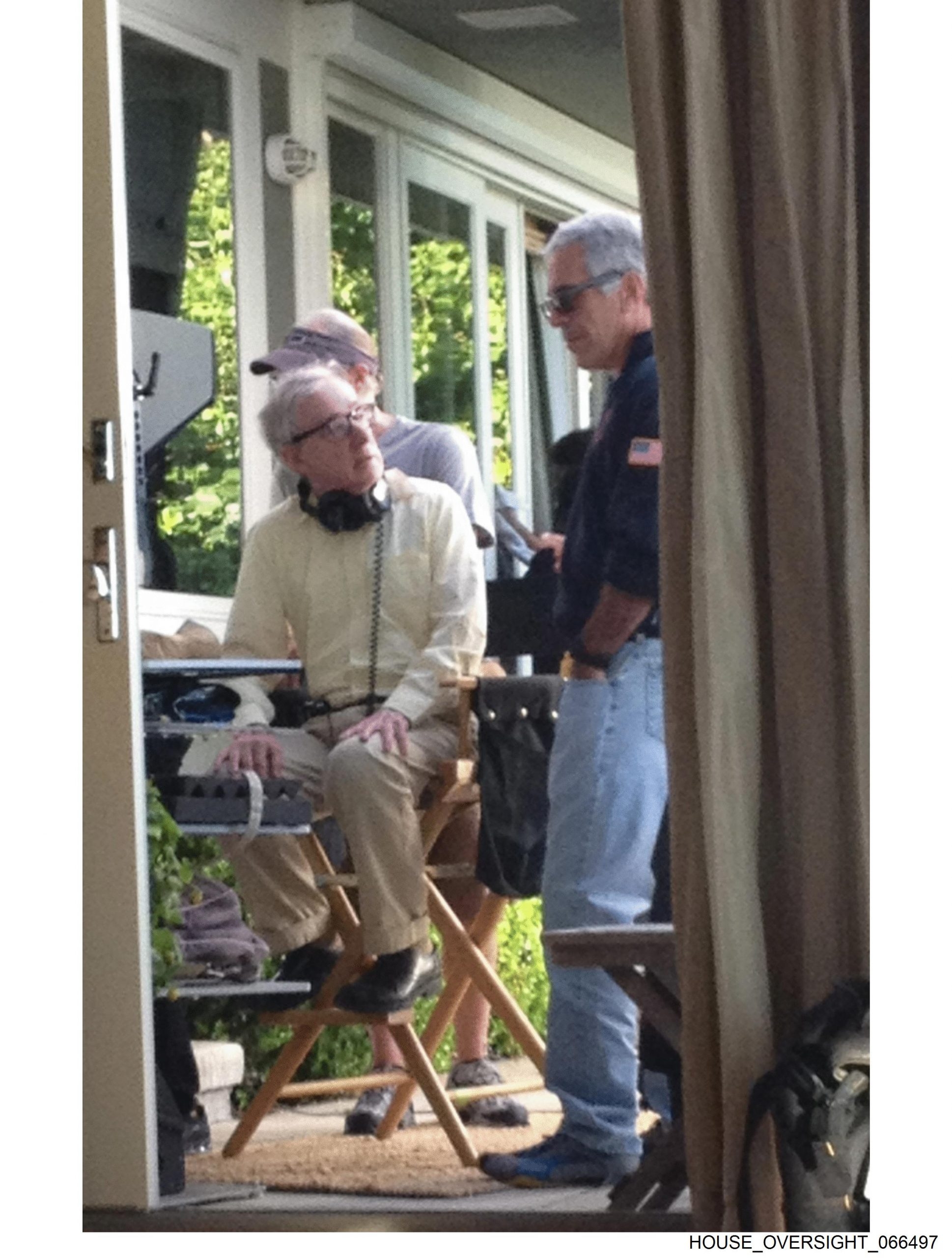  Jeffrey Epstein stands next to Woody Allen, as the filmmaker sits in a director’s chair with a pair of headphones around his neck.