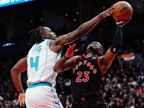 Hornets' Sion James (left) strips the ball from Raptors' Jamal Shead (right) during second half NBA action in Toronto, Friday, Dec. 5, 2025.