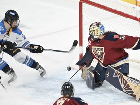 Sceptres' Ella Shelton (left) moves in on Victoire goaltender Ann-Renee Desbiens during third period PWHL action in Laval, Que., Dec. 7, 2025.