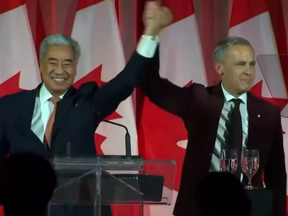 MP Michael Ma, left, with Prime Minister Mark Carney after crossing the floor to the Liberals, in a screengrab from video from CP.