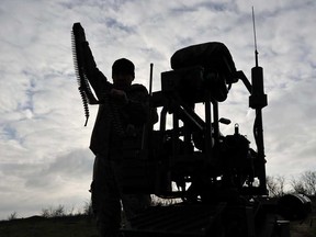 In this photo, provided by Ukraine's 65th Mechanized Brigade press service, a soldier tests land drones in Zaporizhzhia region, Ukraine, Saturday, Dec. 6, 2025.