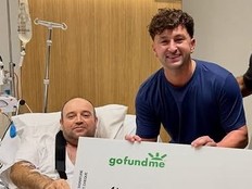 Ahmed Al Ahmed, the man who tackled and disarmed one of the Bondi Beach attackers, at St. George Hospital in Sydney, being presented with a $2.5M cheque from influencer Zachary Dereniowski.