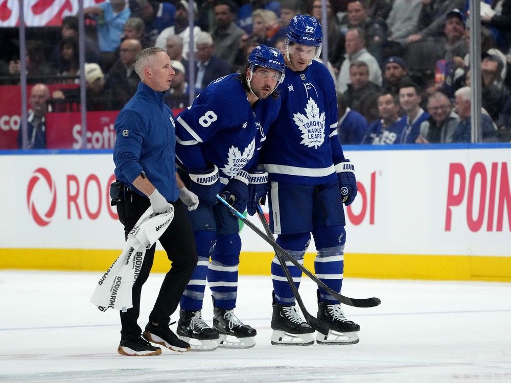 Toronto Maple Leafs defenceman Chris Tanev (8) leaves the ice with an injury during second period NHL hockey action against the New Jersey Devils, in Toronto, Tuesday, Oct. 21, 2025.