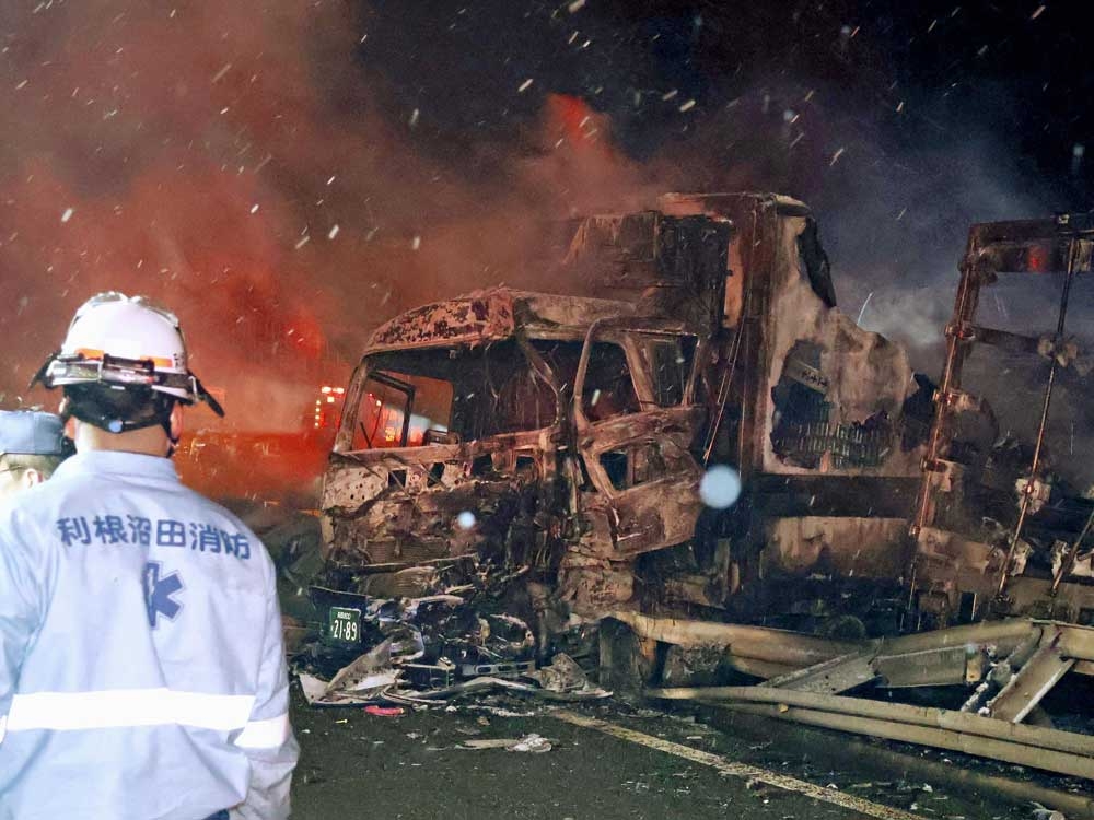  Burnt vehicles are seen after a massive crash in snowy weather on an expressway, in Minakami, northwest of Tokyo, early Saturday, Dec. 27, 2025.