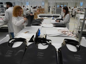 Leather goods operators work at the Prada factory in Scandicci, Italy, Friday, November 28, 2025.