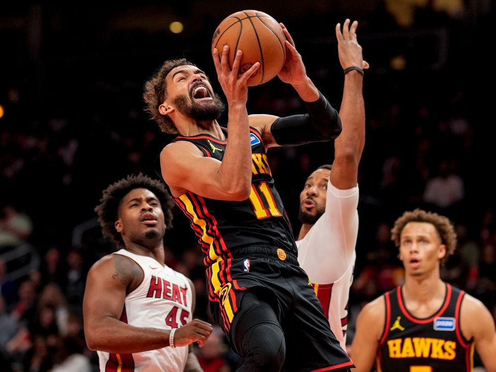 Atlanta Hawks guard Trae Young shoots past Miami Heat guard Davion Mitchell during a game in December.