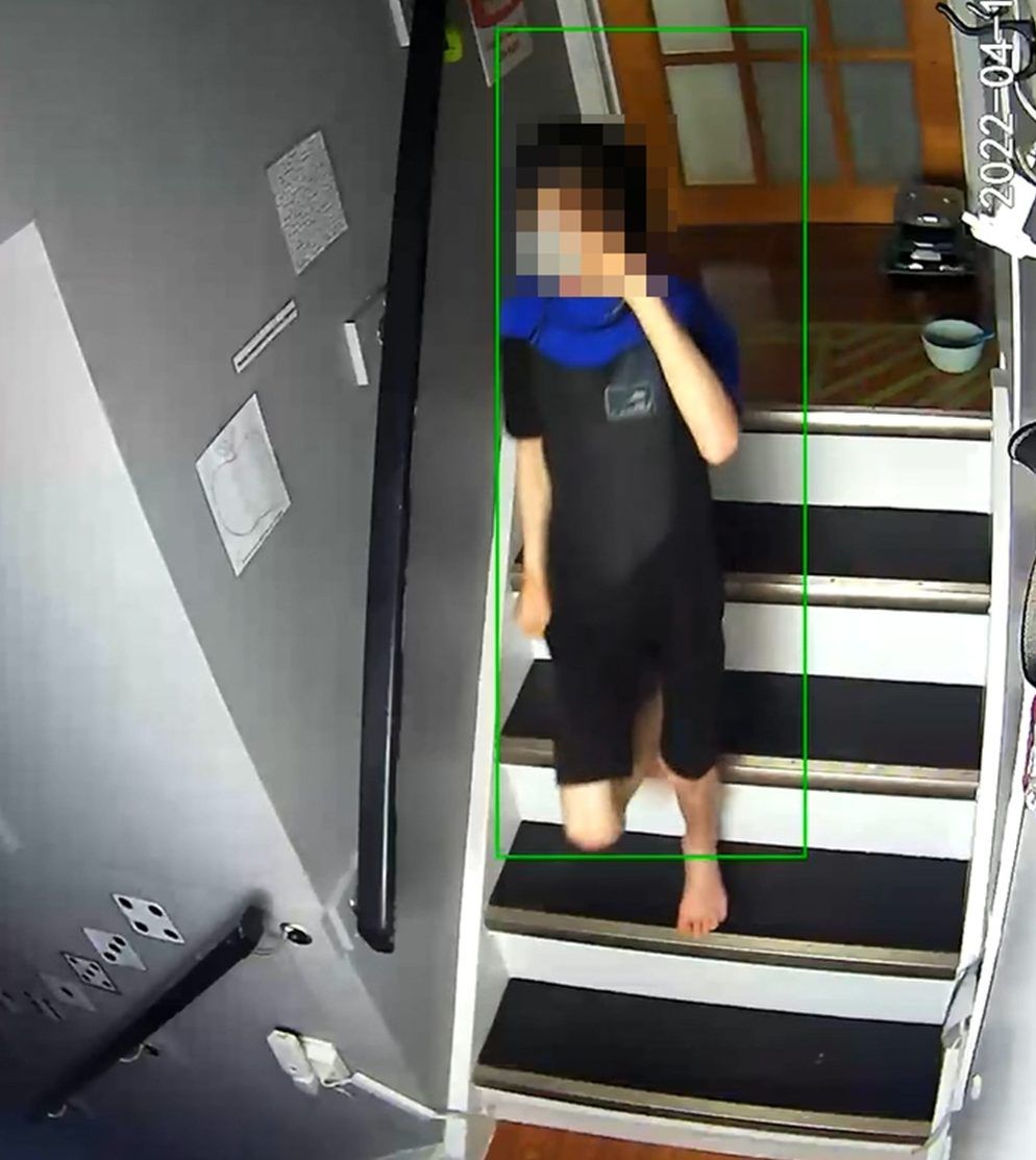 An unidentified boy walking on stairs.