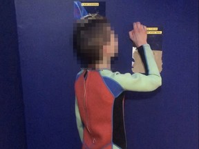 A boy wearing a wet suit.