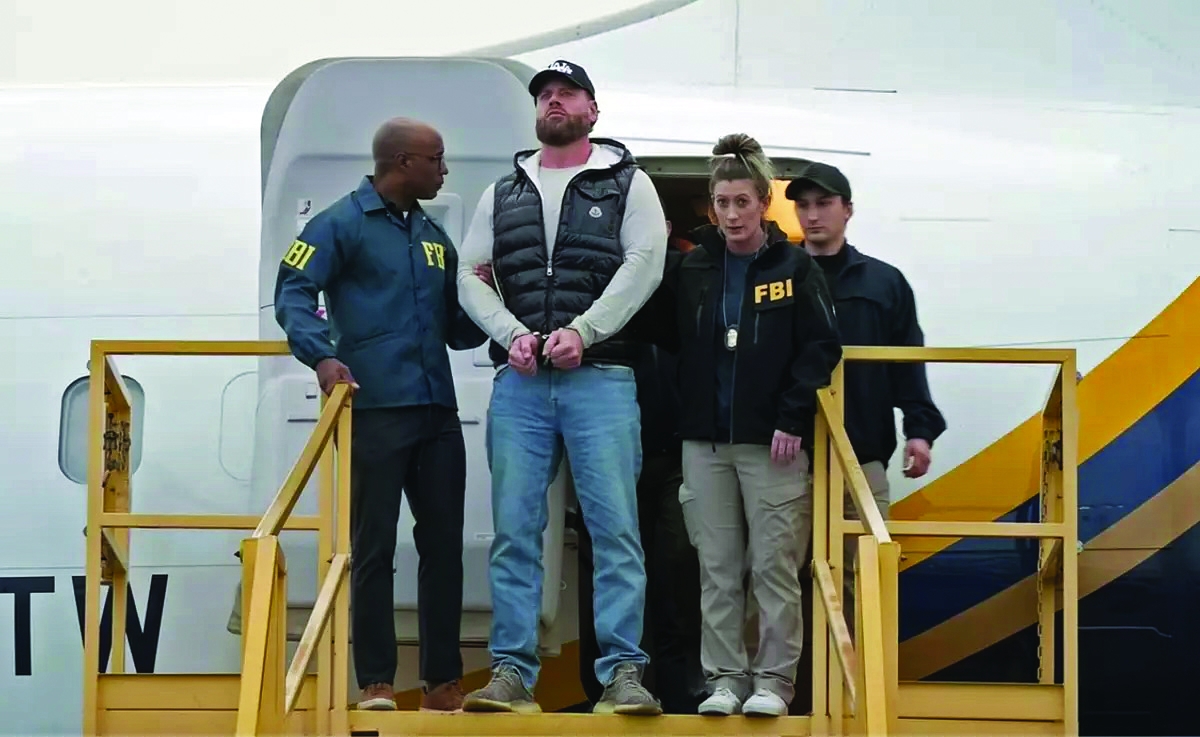  Ryan Wedding is escorted in handcuffs from the plane that brought him from Mexico to the U.S. to face trial after his arrest on Thursday, Jan. 22, 2026.