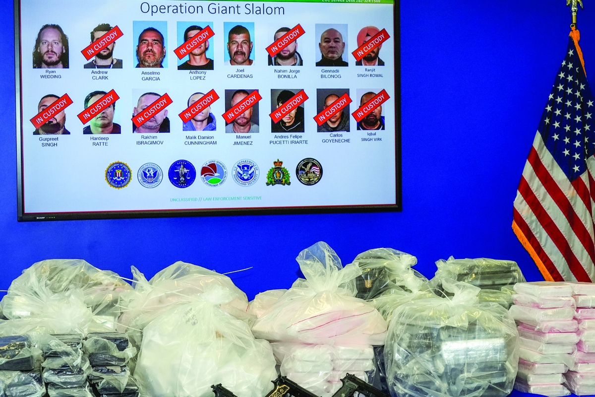  A photo of former Canadian Olympic snowboarder Ryan Wedding, 43, who is a fugitive, is seen top left, with 15 other defendants who have been charged with allegedly running and participating in a transnational drug trafficking operation, is displayed on a video monitor at a news conference at the FBI offices in Los Angeles, on Oct. 17, 2024.