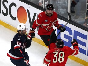 Sam Bennett of Team Canada celebrates a goal with Brandon Hagel.