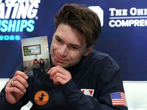 Maxim Naumov holds a photograph of his parents