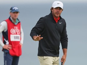 Brooks Koepka, of the United States, acknowledges the crowd on the 5th green during the first round of the British Open golf championship at the Royal Portrush Golf Club in Northern Ireland, July 17, 2025.