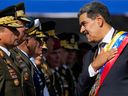 Venezuela's President Nicolas Maduro places his hand over his heart while talking to high-ranking officers during a military ceremony on his inauguration day for a third term, in Caracas, Venezuela, Jan. 10, 2025.