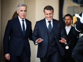 French President Emmanuel Macron gestures as Canada's Prime Minister Mark Carney leaves the Elysee Palace.