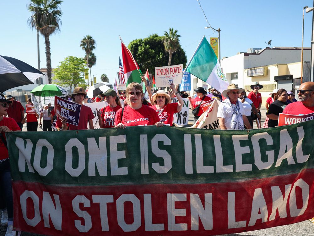 People march with a banner that reads 